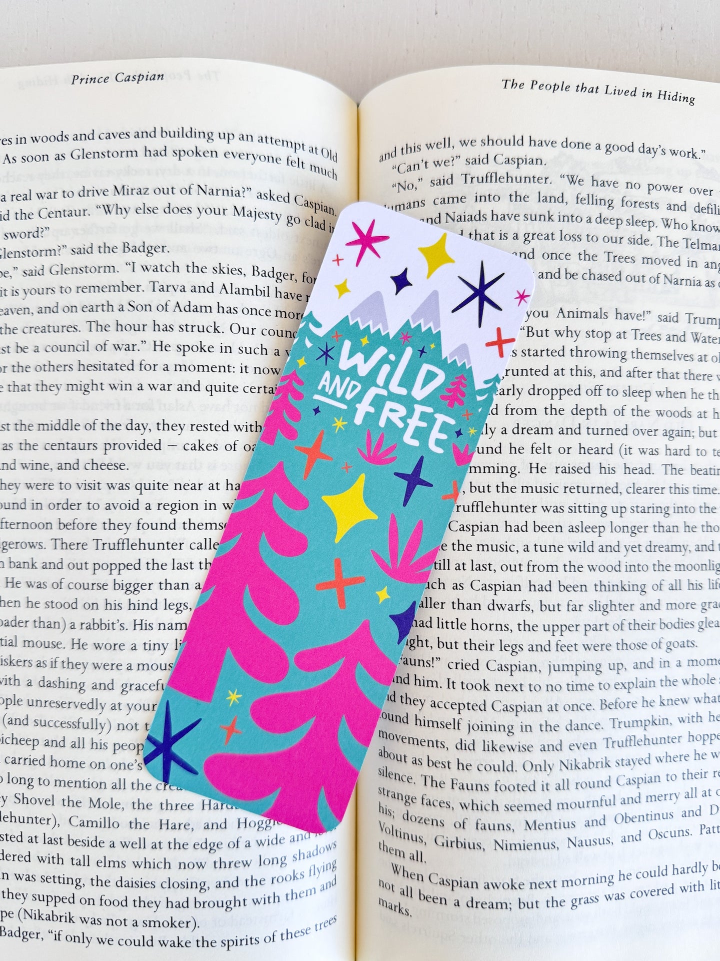 A bookmark placed inside a book. The bookmark features the words 