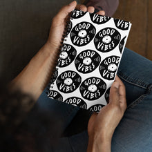 Load image into Gallery viewer, A spiral notebook being held by a person. The white spiral notebook has black spiral binding. The pattern design features the words &quot;good vibes&quot; inside an illustrated vinyl record.  