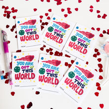 Load image into Gallery viewer, Six classroom valentines on a white tabletop. The valentine reads &quot;You are out of this world&quot; with space-themed illustrations. 