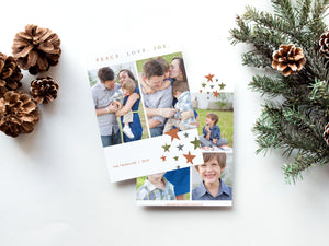 A photo of a double-sided Christmas card showing the front and back of the card laying on a white surface. Around the two sides of the card are pine cones and pine needles. The front of the card features two photos with the words “Peace. Love. Joy.” above the photos. Below the photos are colored stars and a place where you can put your family name. The back of the card features three photos and colored stars. 