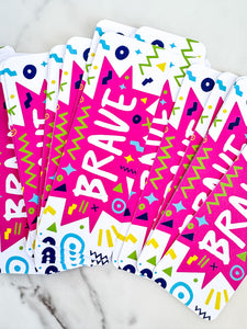 Bookmarks with the word "brave" in white within a star-like pink shape with fun, sketchy elemts around. 