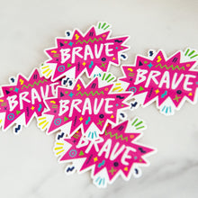 Load image into Gallery viewer, Vinyl die cut stickers with the word &quot;brave&quot; featured inside a pink star-like shape with fun sketchy elements around it. 