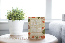 Load image into Gallery viewer, A greeting card is featured on round coffee table with a green plant and sofa in the background. The card features the words &quot;You have always made me feel so welcome at your table. Thank you for the ways You love others so well&quot; with illustrated leaves surrounding the words.
