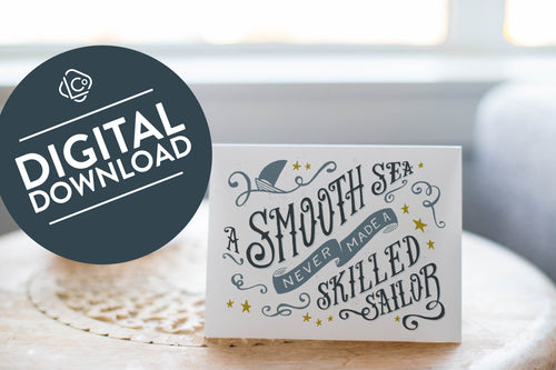 A greeting card laying on a wooden table with some cut wood details. The card features the words “A smooth sea never made a skilled sailor.” The words 