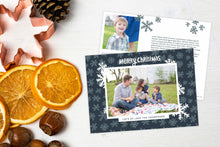 Load image into Gallery viewer, A photo of a Christmas card showing the front and back of the card laying on a white surface. Left of the card is a cookie cutter, pinecone, nuts and dried oranges. The front of the card features a photo with a frame around it with illustrated snowflakes. Above the photo reads “Merry Christmas” and below the photo you can add your family name. The back of the card features two photos, illustrated snowflakes and a place to add a family update.