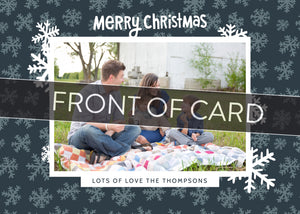 A close up of the front of the card showing the front of the card design. Across the image is a gray strip with the words “front of card” on it. The front of the card features a photo with a frame around it with illustrated snowflakes. Above the photo reads “Merry Christmas” and below the photo you can add your family name. 