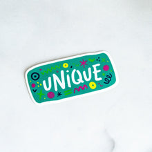 Load image into Gallery viewer, A vinyl die cut sticker with the word &quot;unique&quot; and sketchy elements surrounding the word. 