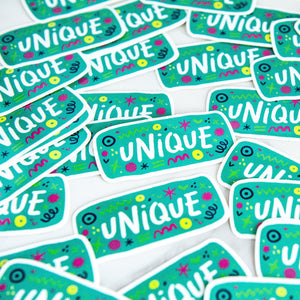 Vinyl die cut stickers with the word "unique" and sketchy elements surrounding the word. 