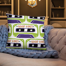 Load image into Gallery viewer, A white pillow on a sofa with a blue blanket. The white pillow features the artwork on a white background with an illustrated cassette tape pattern with the words &#39;good vibes.&#39;