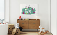 Load image into Gallery viewer, A large white flag featured on a wall of a kids&#39; bedroom. The white flag features the words &#39;wild and free&#39; inside illustrated mountains with sketch trees and other elements around.