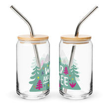 Load image into Gallery viewer, A photo of two glass can tumblers on a white background showing the side of the glasses. The glass tumblers have a bamboo lid and silver metal straw. The design on the glass tumbler says the words &quot;wild and free&quot; inside illustrated mountains with sketchy trees around. 