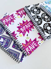 Load image into Gallery viewer, A set of four spiral bound notebooks. The notebooks feature a pattern design  with the words brave, dream, good vibes and I love books. 