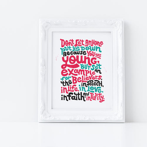 A print featured in a white frame with the lettering in red, blue and black. The Bible verse reads 
