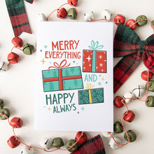 Load image into Gallery viewer, A Christmas card featured on top of some red and white Christmas decorations. The card has a white background with the words &quot;Merry Everything and Happy Always.&quot; There are three illustrated Christmas gifts in light red, green and blue with patterns on them.
