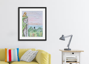 A black frame above a yellow sofa. The frame features a scene on a mountain top with Aslan and Peter overlooking Narnia.  
