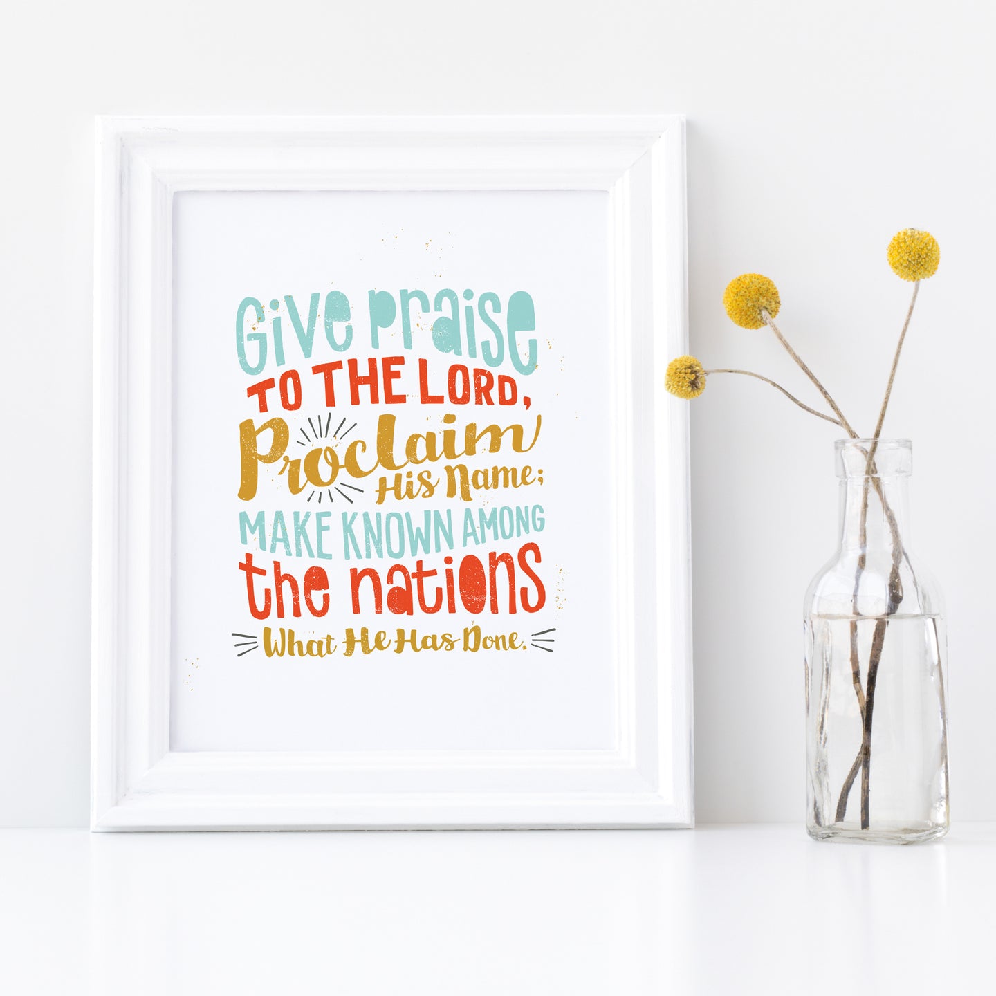 Artwork in a white frame with the artwork printed on white paper and colorful hand drawn lettering with the Psalm 105:1 