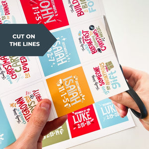 An image of hands cutting the Advent calendar cards. The words "cut on the lines" are over the image. 