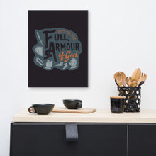 Load image into Gallery viewer, A dark gray canvas hangs on a white kitchen wall, over black cups and wooden utensils sitting on a black sideboard. The canvas features the quote &#39;Put on the full armour of God&#39; in black and orange typography, with medieval-style pieces of armour illustrated in pale gray.