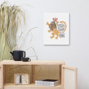 A white canvas hanging above a shelf with a plant beside it. The artwork features hand drawn illustration of the Chronicles of Narnia lion character Aslan. Inside the illustration there is the quote "Course He Isn't Safe, But He's Good. He's the King."