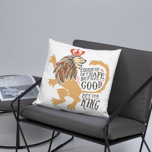 A white pillow sitting on a grey padded wire chair. The artwork features hand drawn illustration of the Chronicles of Narnia lion character Aslan. Inside the illustration there is the quote "Course He Isn't Safe, But He's Good. He's the King."