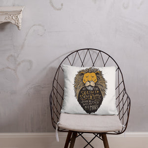 A white pillow featured on a wire chair. The pillow artwork features hand drawn illustration of the Chronicles of Narnia lion character Aslan. Inside the illustration there is the quote “At The Sound of Your Roar, Sorrows Will Be No More.”
