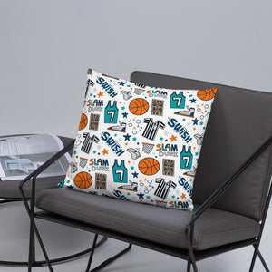 A basketball themed illustrated pillow is on a grey cushion chair with black metal sides. Next to the chair is a grey coffee table. 