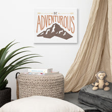 Load image into Gallery viewer, Canvas hanging a wall in a children’s room. The canvas features the words “Be adventurous” with arrows pointing to the word “be” and a brown mountain illustration underneath the word “adventure.”