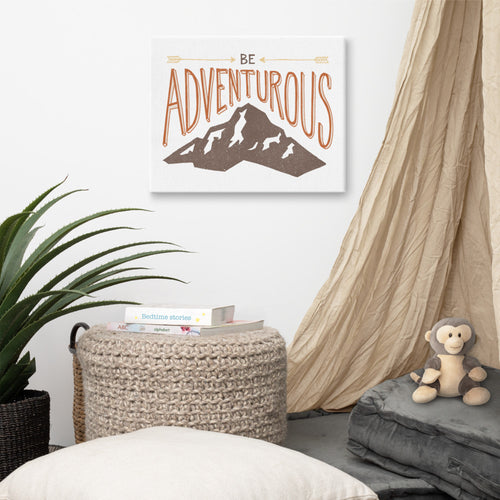 Canvas hanging a wall in a children’s room. The canvas features the words “Be adventurous” with arrows pointing to the word “be” and a brown mountain illustration underneath the word “adventure.”