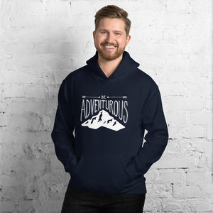 A man wearing a navy hoodie with lettering and illustration in white with the phrase “Be Adventurous” with arrows pointing to the word “be” and a mountain illustration underneath the word “adventure.”