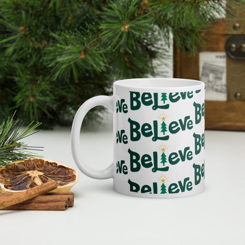 A white mug with a pine tree in the background. The mug feaures the word 