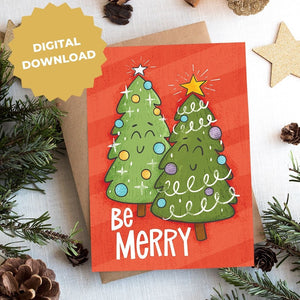 A photo of a Christmas card on top of a brown paper wrapped gift with Christmas decor around it. The Christmas card has a red background with two illustrated cute Christmas trees and the words "Be Merry" in white. The words "Digital Download" are featured on top of the photo.
