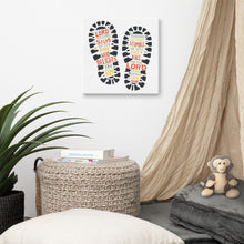 Load image into Gallery viewer, A canvas shown on a wall in a kids&#39; room. The artwork features illustrated footprints in black with the words in grey, yellow and orange. The words read &quot;The Lord makes firm the steps of the one who delights in him. Though he may stumble, he will not fall, for the Lord upholds him with his hand.&quot;