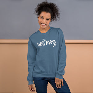 A indigo blue sweatshirt featuring the phrase Dog Mom in white lettering with white heart shaped paws around the words. 