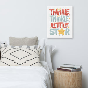 A canvas hanging above a bed. The cavnas is white and features hand drawn lettering reading "Twinkle Twinkle Little Star" The word star features a "star" for the A. 
