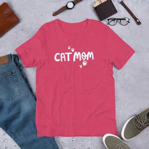 A comfy short sleeve T-shirt in a raspberry pink color featuring the words Cat Mom with heart shaped paws surrounding the words. The paws and words are in white. The tee is a wonderful gift for cat owners. 