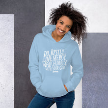 Load image into Gallery viewer, A woman wearing a light blue hoodie with the Bible verse words Do justly, love mercy, walk humbly, with your God, Micah 6:8 in white lettering. 