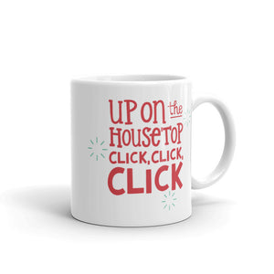 A white ceramic mug featured on a white background. The design is in red with the words "Up on the housetop click, click, click" with small blue stars around the words.  