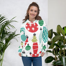 Load image into Gallery viewer, A woman wearing a white hoodie with an illustrated ornament pattern featured all over the fabric including the hood. The colors of the ornaments are red, light green and dark green, blue and light blue. 