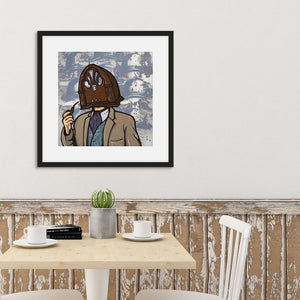 A black frame above a kitchen table featuring an illustration of a vintage radio as a "head" of a person in a suit who is smoking a pipe. 