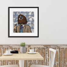 Load image into Gallery viewer, A black frame above a kitchen table featuring an illustration of a vintage radio as a &quot;head&quot; of a person in a suit who is smoking a pipe.