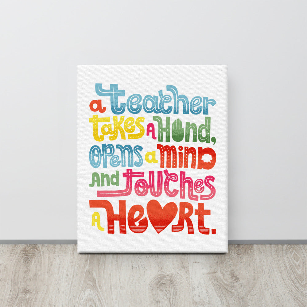 A canvas with artwork featuring “A teacher takes a hand, opens a mind, and touches a heart.” The “a” in the word “heart” is a heart shape and the words are blue, red, yellow and green. 