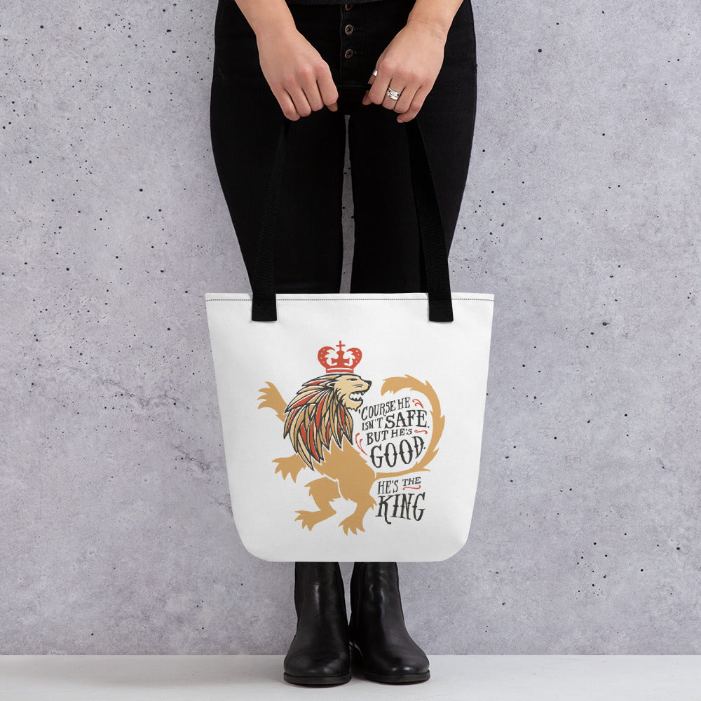 A woman holding a white tote bag with black handles. The artwork features an illustrated with the words 