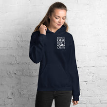 Load image into Gallery viewer, A woman wearing a navy hoodie with the word &quot;create, create, create, create, create&quot; in white in a small rectangle on the upper left side.