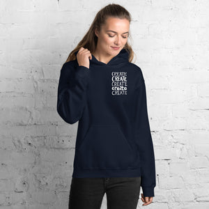 A woman wearing a navy hoodie with the word "create, create, create, create, create" in white in a small rectangle on the upper left side.