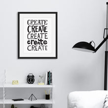 Load image into Gallery viewer, Artwork featured in a black frame on a wall featured in a living room. The artwork is on a white paper with black lettering in the word “create” written five times. 