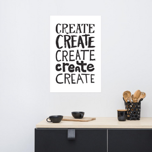 Artwork featured in a black frame in a kitchen. The artwork is on a white paper with black lettering in the word “create” written five times. 