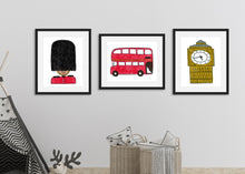 Load image into Gallery viewer, Three black frames with London illustrations in the frame. The first illustration is a queen&#39;s guard, the second a red double decker bus and the third, an illustration of Big Ben. The frames are shown in a nursery with a children&#39;s tent. 