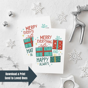 Two Christmas cards laying on a white background with white and silver Christmas decorations on the table. The card has a white background with the words "Merry Everything and Happy Always." There are three illustrated Christmas gifts in light red, green and blue with patterns on them. On lefthand corner is a navy arrow with the words 'download & print, send to loved ones."
