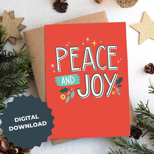 A photo of a Christmas card on top of a brown paper wrapped gift with Christmas decor around it. The card has a red background with the words "peace and joy" in white and illustrations of stars and holly leaves around the wording. The words "digital download" are on top of the image. 