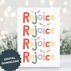 A Christmas card standing up with with pine leaves in the background with a touch of snow. The card has a white background and features the word "rejoice" repeated four times. The letters of the word are in different colors of muted red, yellow, green, purple and pink. The words "digital download" are on top of the image.